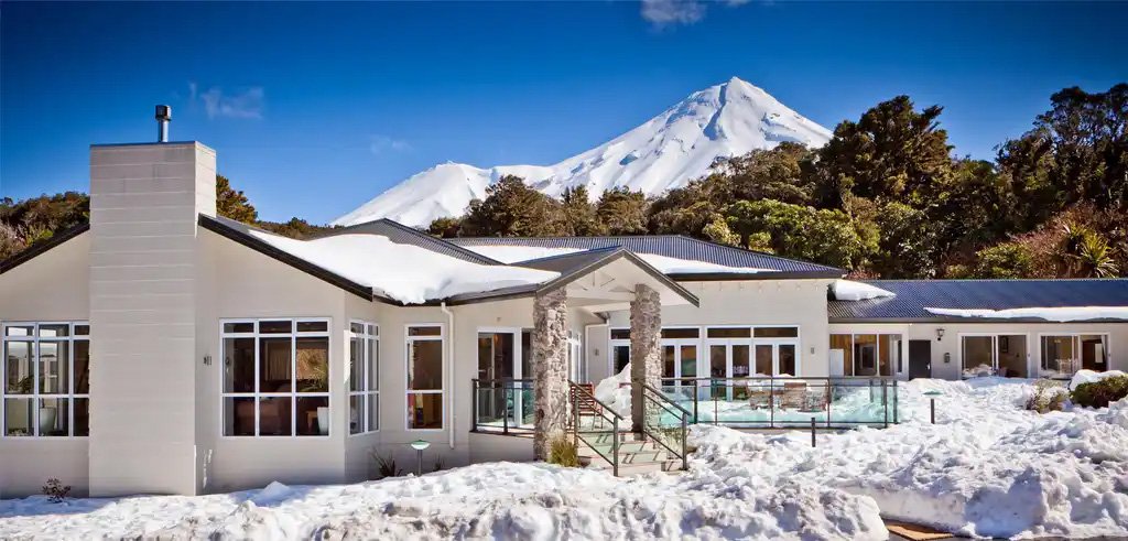 Snow outside Mountain Lodge Stratford with Mt Taranaki in the background