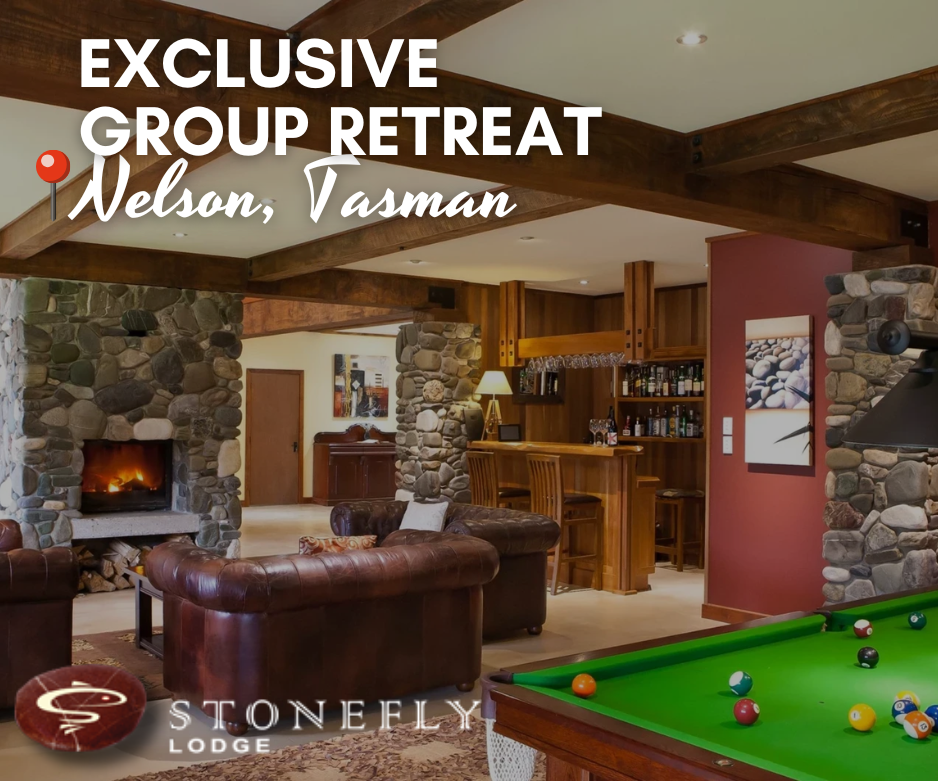 Exclusive luxury group retreat at Stonefly Lodge featuring a cosy lounge with stone fireplace and bar — premium accommodation in Nelson Tasman ideal for fishing trips, private events, and group getaways