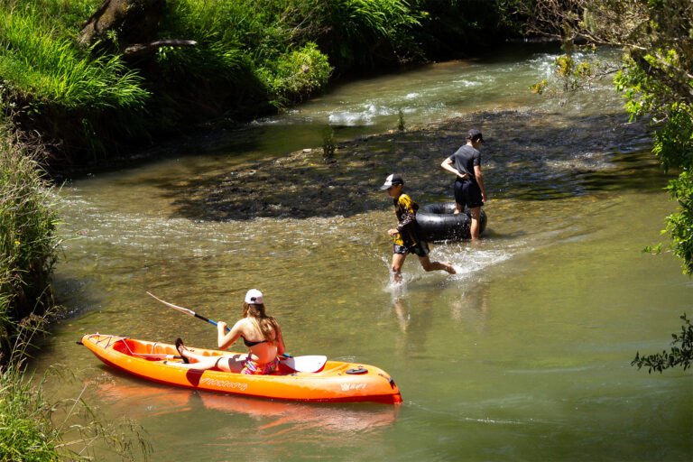 family playing in stream at ripples retreat waikato 768x512