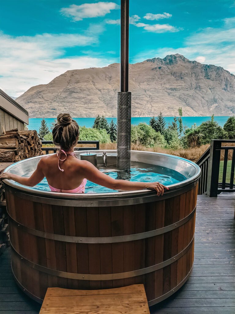 lady in hot tub at hidden lodge overlooking lake wakatipu 768x1024