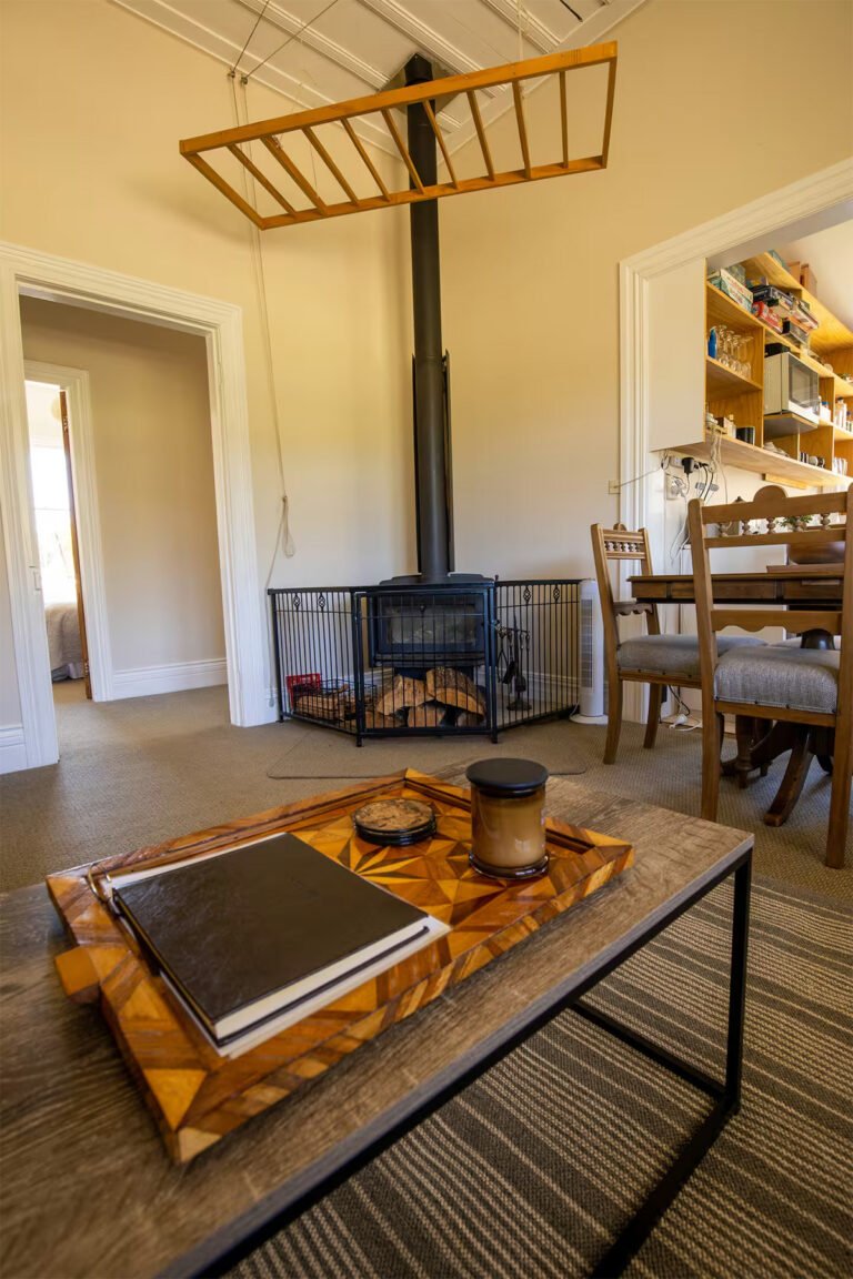 whangamomona accommodation fireplace living room 768x1152