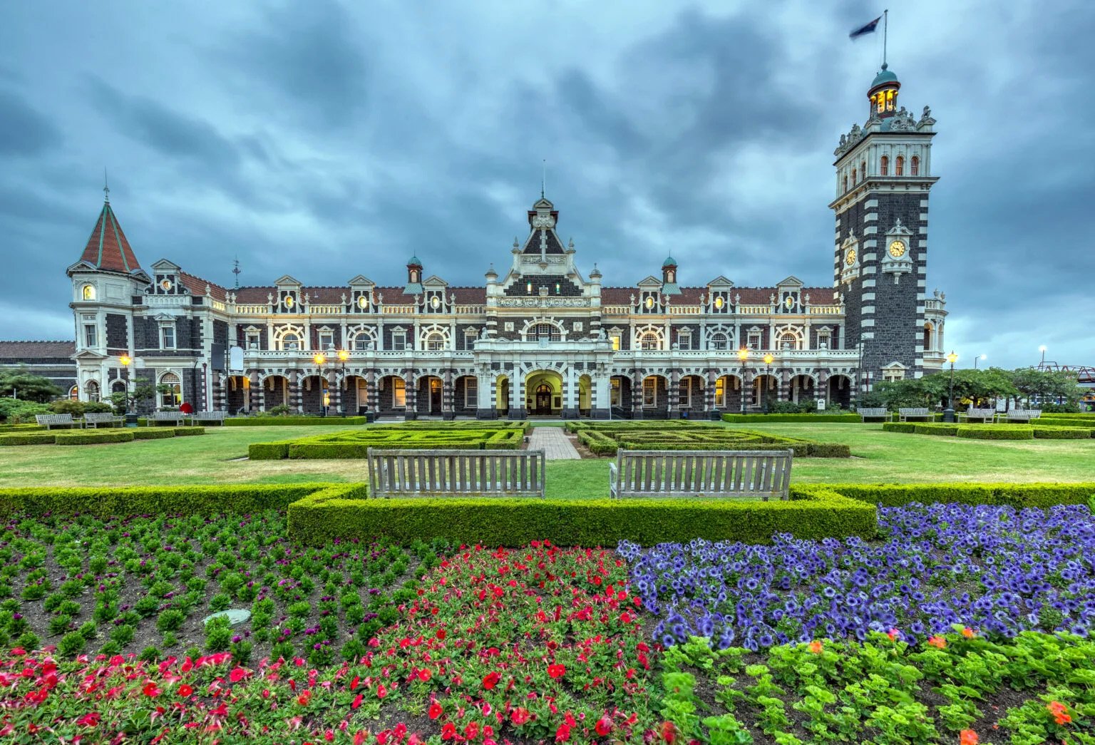 Dunedin railway station building surrounded by gardens