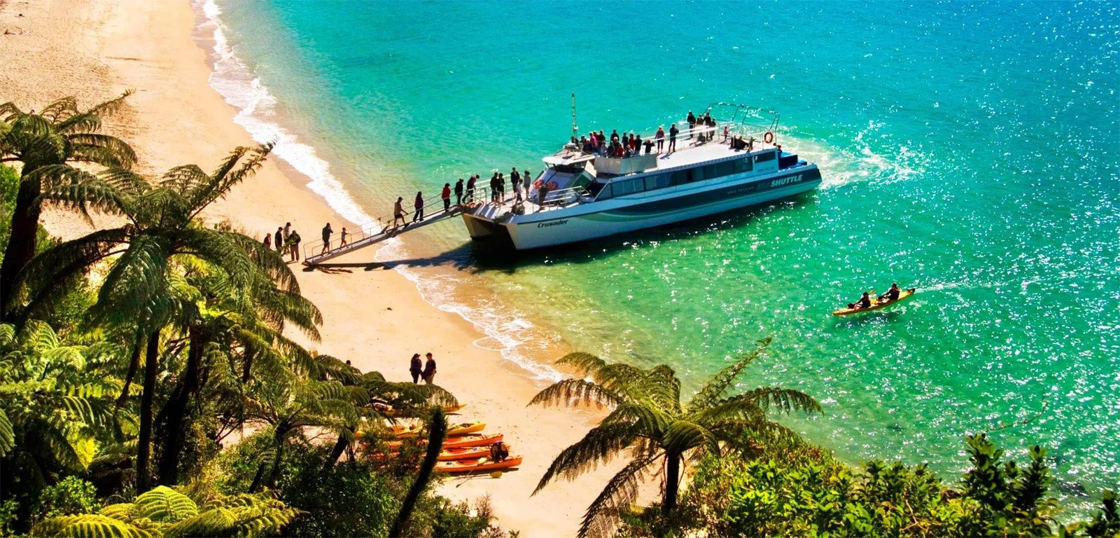 Abel Tasman Sea Shuttle boat arriving at Kaiteriteri beach with passengers