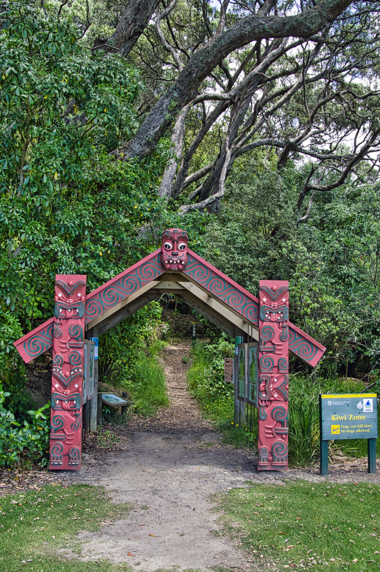 Traditional Māori carved entrance in native forest Bay of Plenty New Zealand