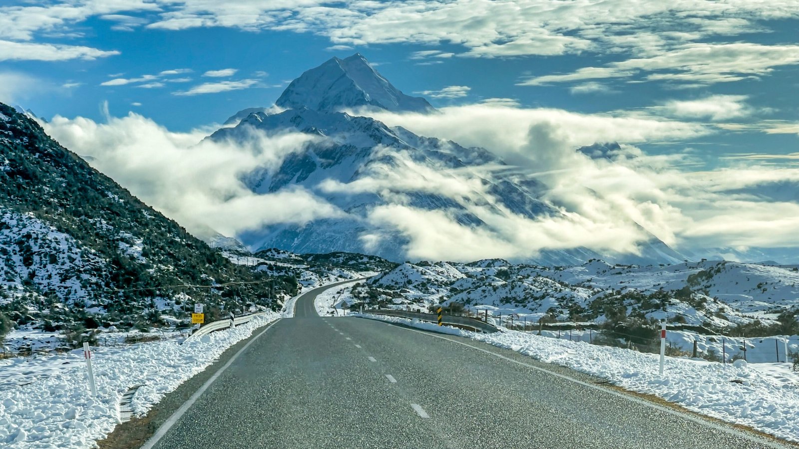 Snow-covered road leading to Aoraki / Mount Cook on a South Island winter road trip
